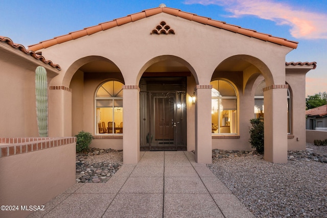 view of exterior entry at dusk