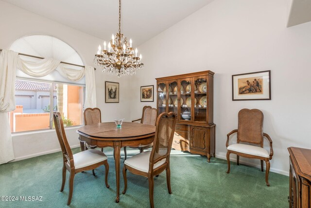 carpeted dining area featuring a notable chandelier and high vaulted ceiling