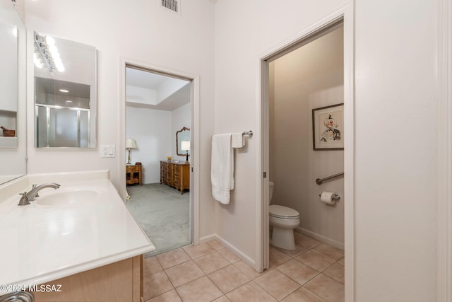 bathroom with an enclosed shower, tile patterned flooring, toilet, and vanity