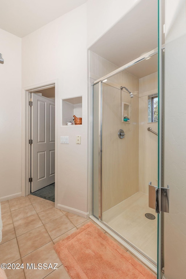 bathroom with tile patterned flooring and an enclosed shower