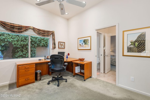 carpeted office space with ceiling fan