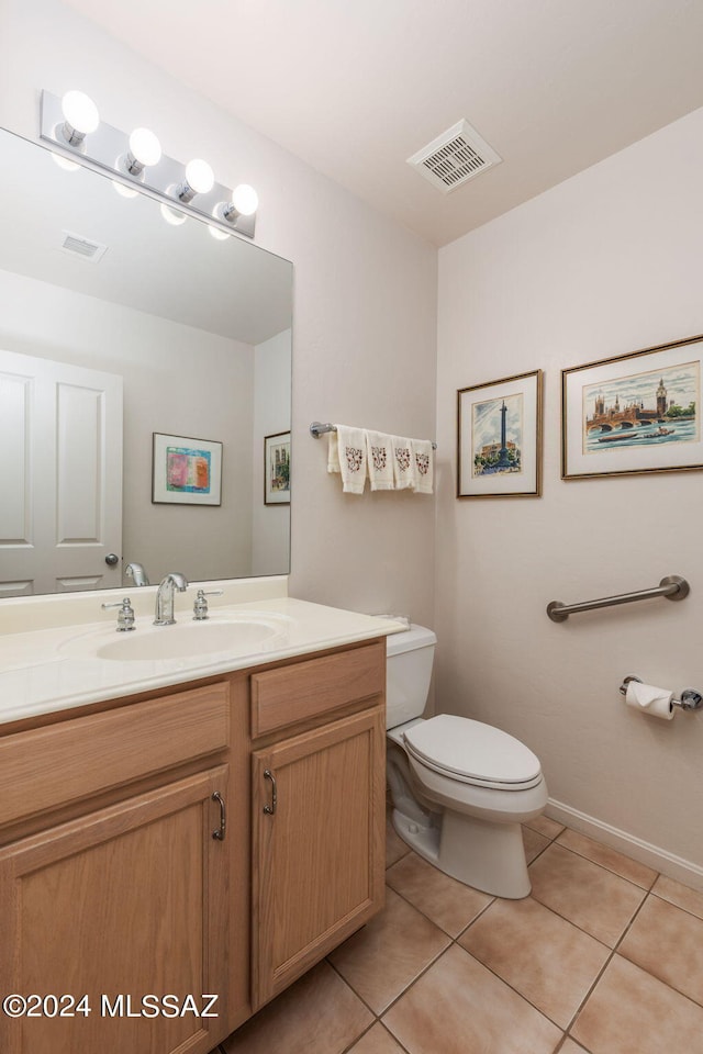 bathroom with vanity, toilet, and tile patterned flooring