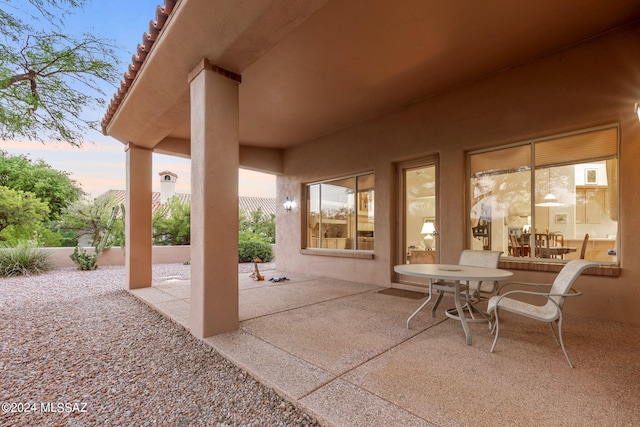 view of patio terrace at dusk