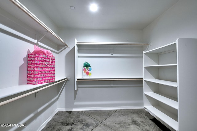 spacious closet with dark tile patterned flooring