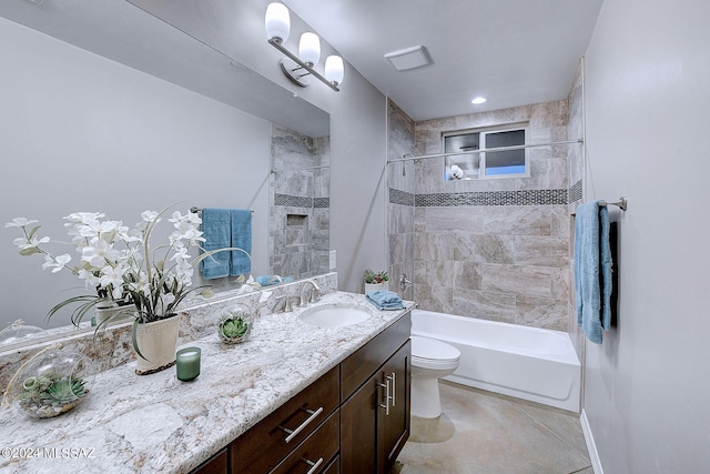 full bathroom with tile patterned flooring, toilet, tiled shower / bath combo, and vanity