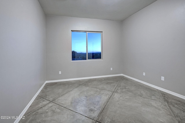 unfurnished room with concrete floors