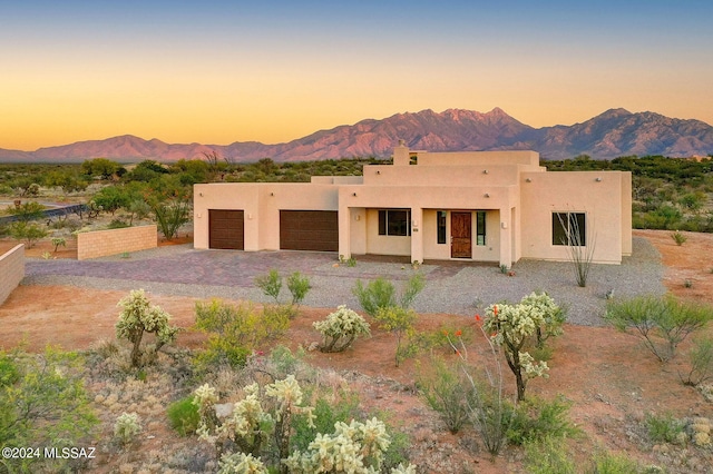 southwest-style home with a mountain view and a garage