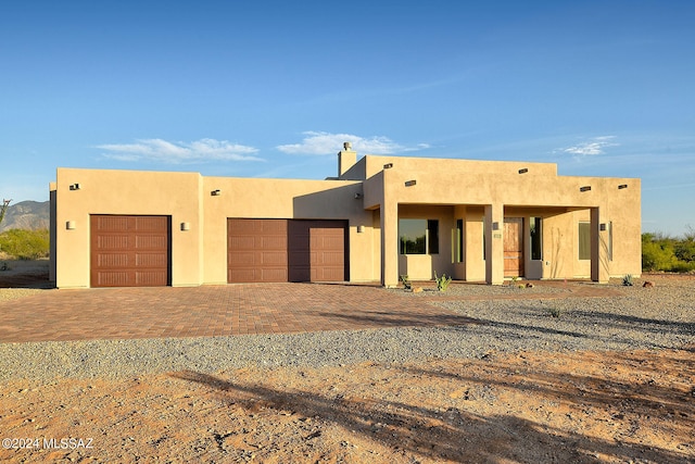 pueblo-style home featuring a garage