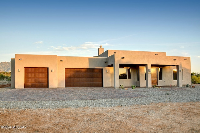 pueblo-style home with a garage