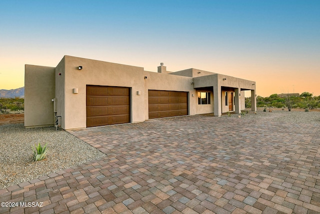 pueblo-style home featuring a mountain view and a garage