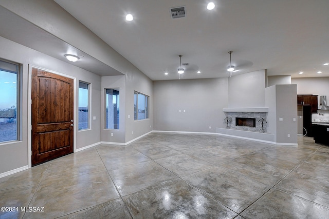 interior space with ceiling fan and a premium fireplace