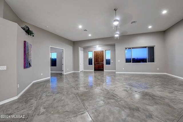 unfurnished living room with concrete flooring