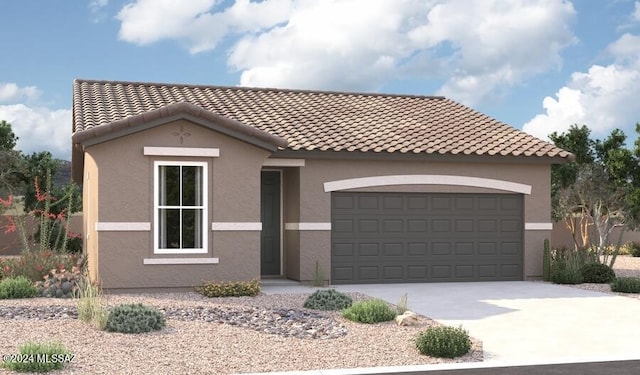 mediterranean / spanish house featuring a garage, driveway, a tile roof, and stucco siding