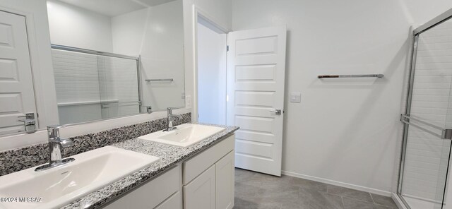 bathroom featuring tile patterned flooring, walk in shower, and vanity