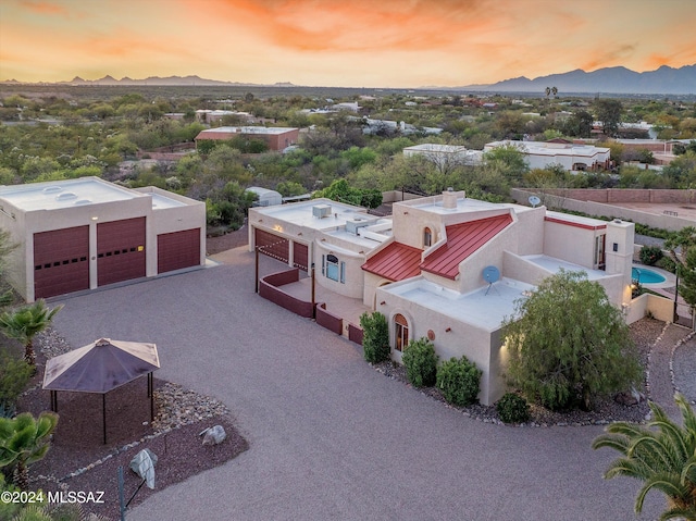 aerial view at dusk featuring a mountain view