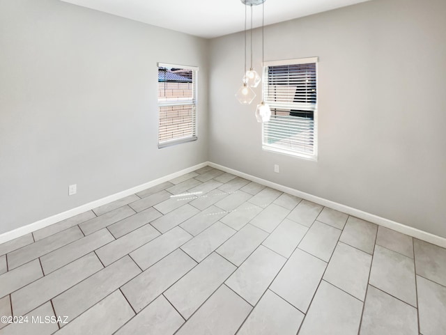 unfurnished room featuring baseboards