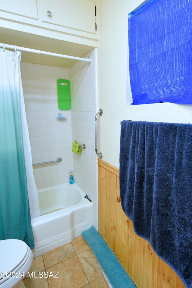 bathroom with tile patterned flooring, toilet, and shower / tub combo with curtain