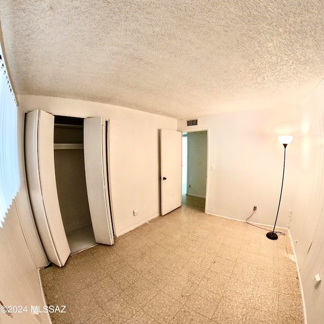 unfurnished bedroom featuring a textured ceiling