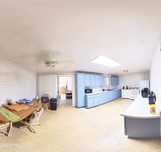 kitchen with ceiling fan, white stove, and sink