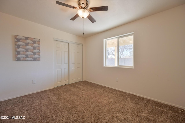 unfurnished bedroom featuring carpet, a closet, and ceiling fan