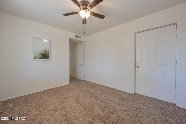 spare room featuring carpet flooring and ceiling fan