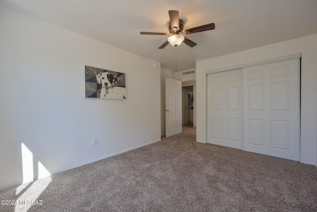 unfurnished bedroom featuring carpet, ceiling fan, and a closet