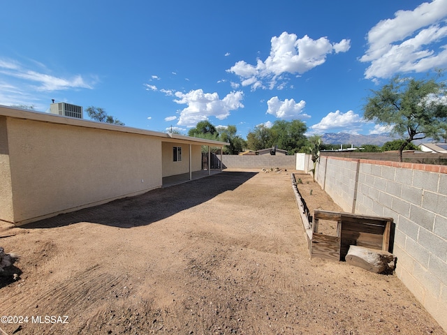 view of yard with a mountain view and central AC unit