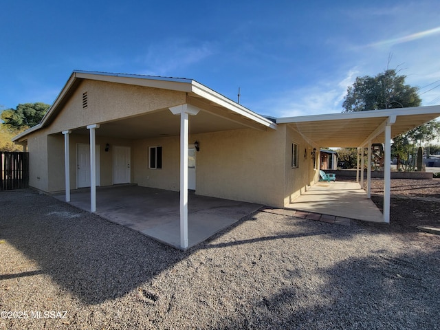 back of house with a carport