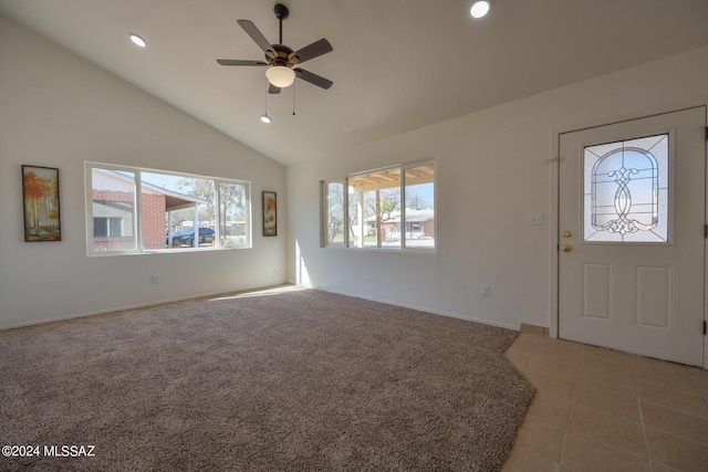 entryway with light colored carpet, high vaulted ceiling, a wealth of natural light, and ceiling fan