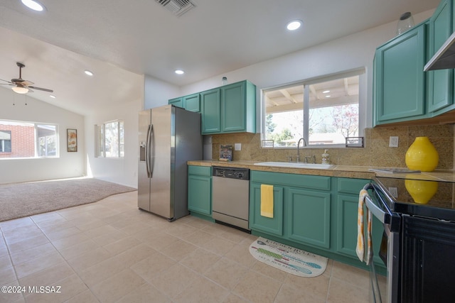 kitchen featuring appliances with stainless steel finishes, ceiling fan, sink, green cabinetry, and lofted ceiling