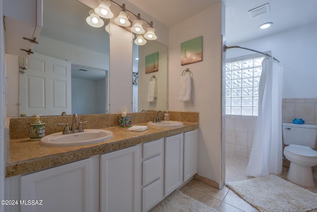 bathroom featuring tile patterned floors, a shower with curtain, toilet, and vanity