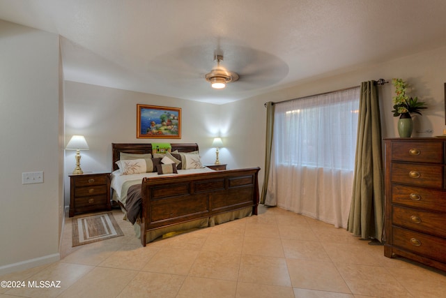 tiled bedroom with ceiling fan