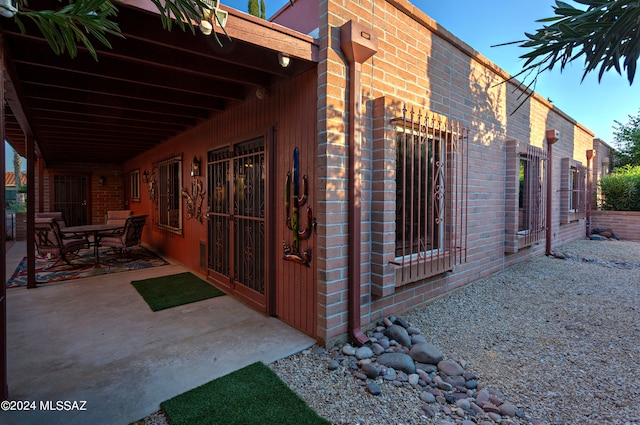 view of side of home with a patio area