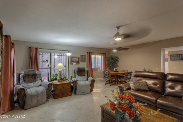 living room with ceiling fan and light tile patterned floors