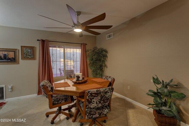 tiled dining room with ceiling fan