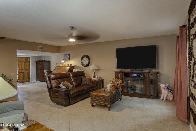 tiled living room with ceiling fan