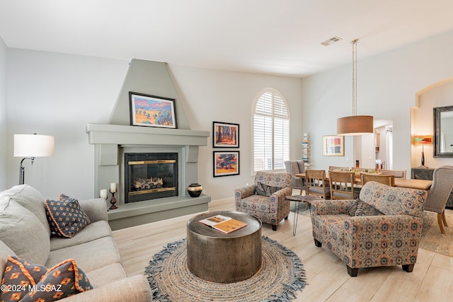 living room with a fireplace and light hardwood / wood-style floors