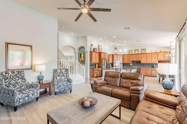 living room with light wood-type flooring and ceiling fan