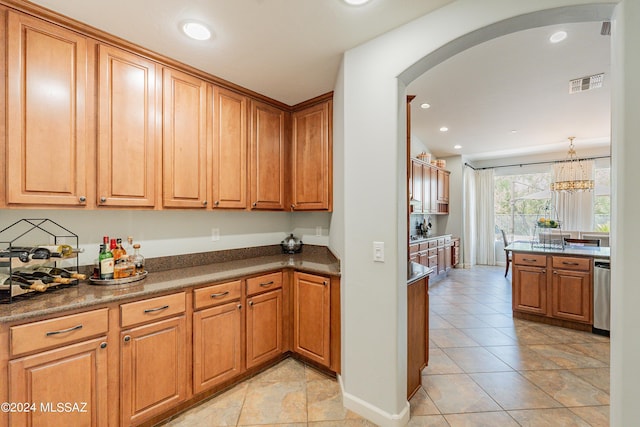 kitchen featuring dishwasher, hanging light fixtures, and a notable chandelier