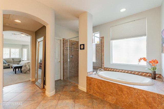 bathroom featuring tile patterned floors and separate shower and tub