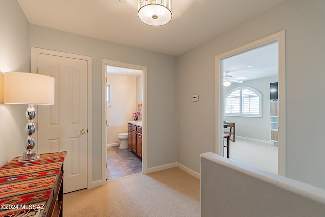 hallway featuring light colored carpet