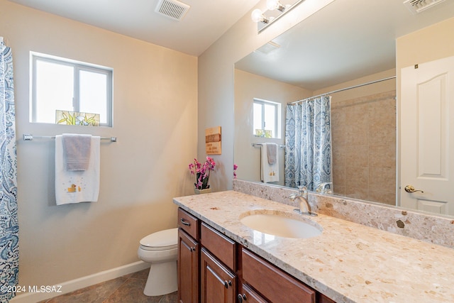 bathroom with tile patterned flooring, vanity, curtained shower, and toilet