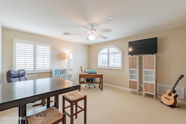 dining area featuring carpet flooring and ceiling fan