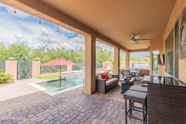 view of patio featuring outdoor lounge area, ceiling fan, and pool water feature