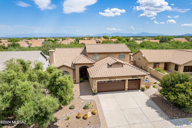 mediterranean / spanish-style house featuring a mountain view and a garage