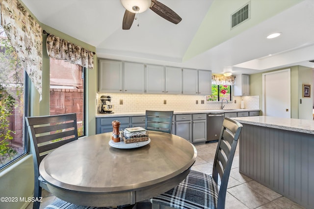 dining area featuring vaulted ceiling, sink, ceiling fan, and light tile patterned flooring