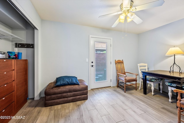 living area featuring ceiling fan and light hardwood / wood-style flooring