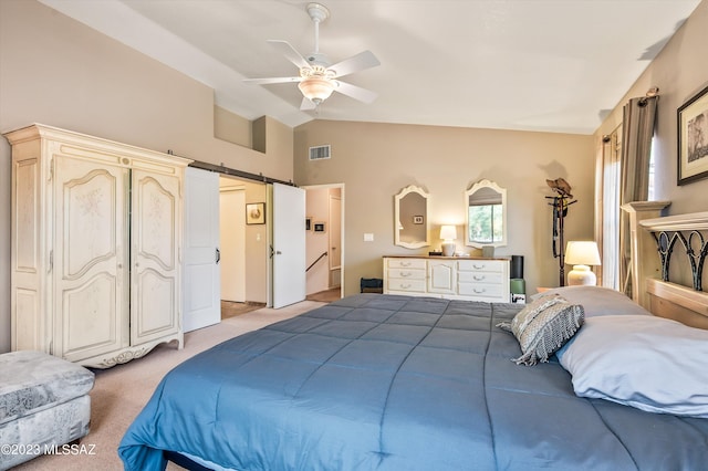 carpeted bedroom featuring a barn door, ceiling fan, and vaulted ceiling