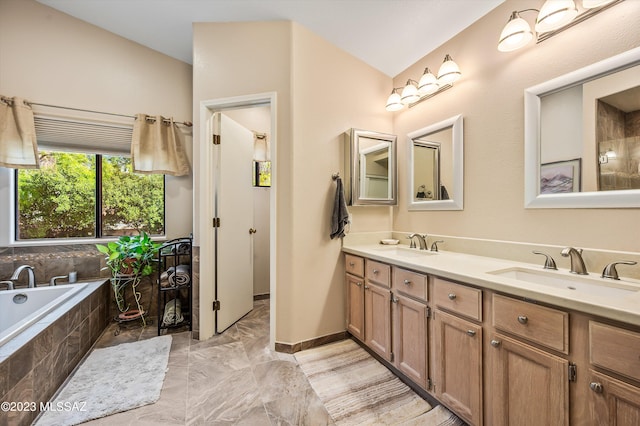 bathroom with vanity and tiled tub