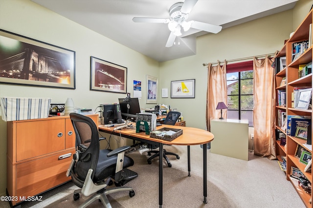 carpeted office featuring ceiling fan